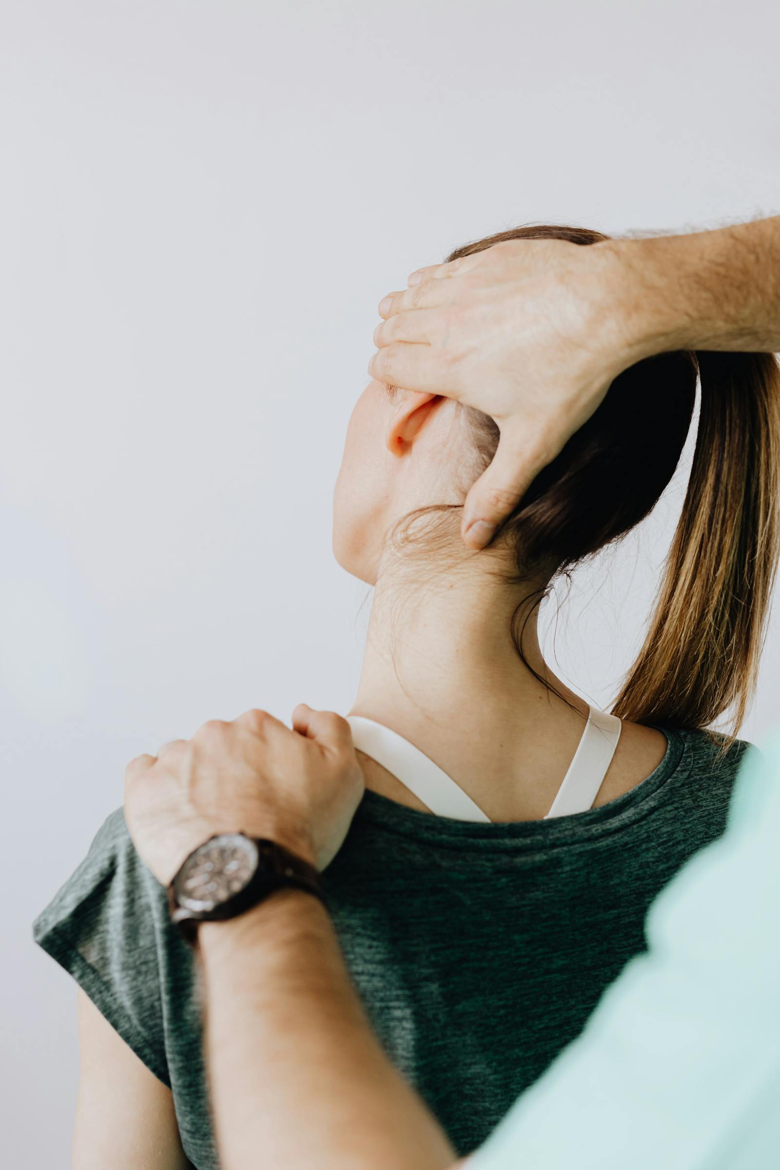 Practitioner cradling a patient's head and cervical spine during an upper cervical adjustment
